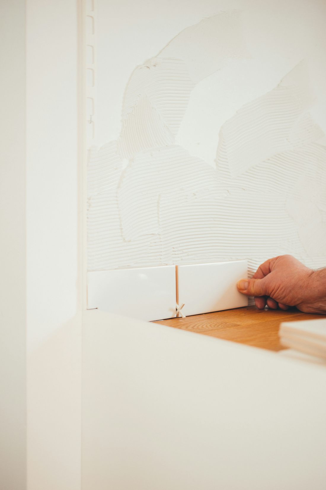 Installer placing a white tile